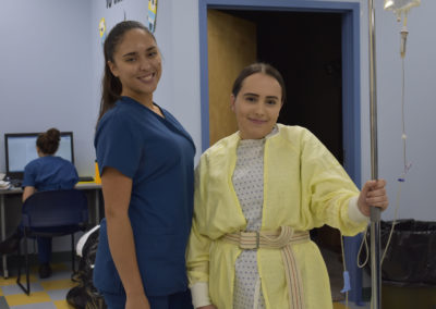 Nursing Assistant students smiling with an IV