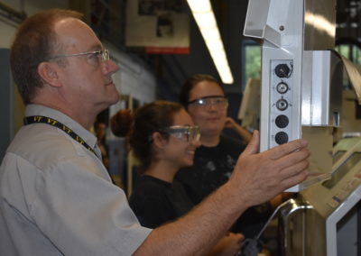 Machine Technology teacher working with equipment