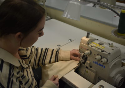 fashion design students sewing fabric