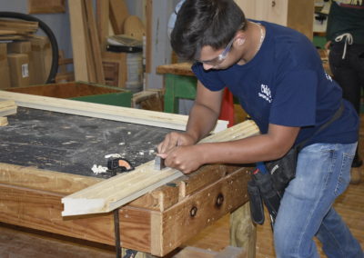 Carpentry student shaving wood