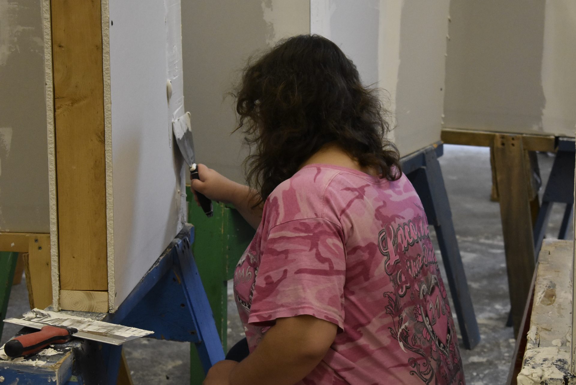 Painting and Design student working on wall