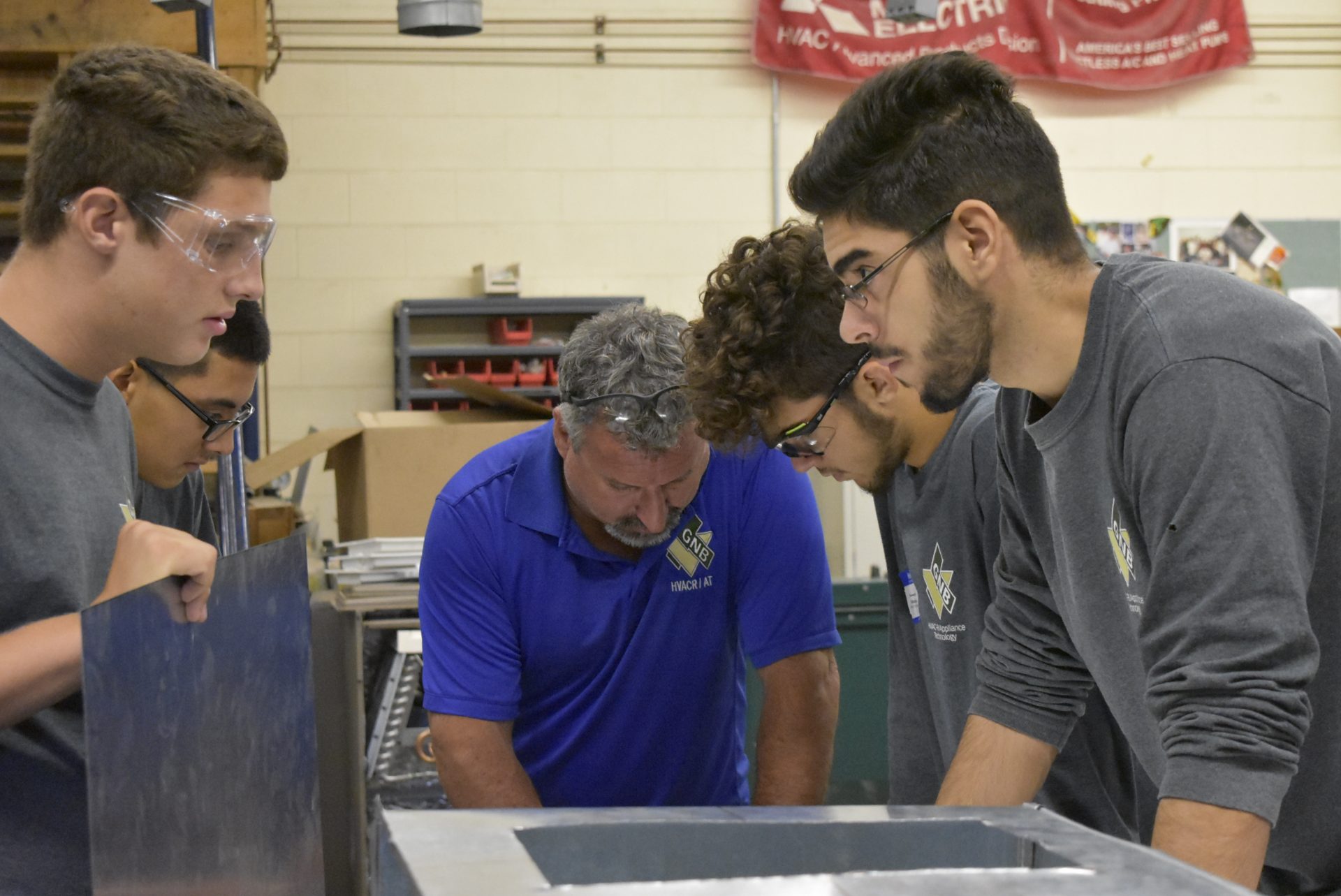 HVAC students working with teacher