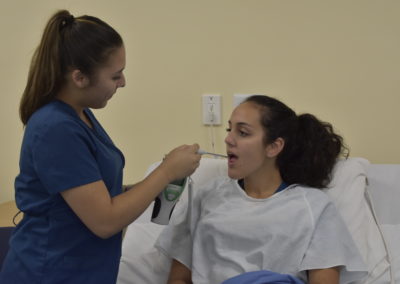 Nursing Assistant student checking temperature