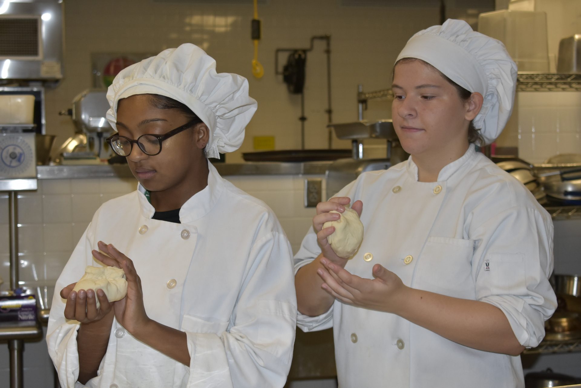 Culinary Culinary students kneading dough