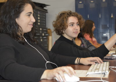 Visual Design students helping each other on the computer