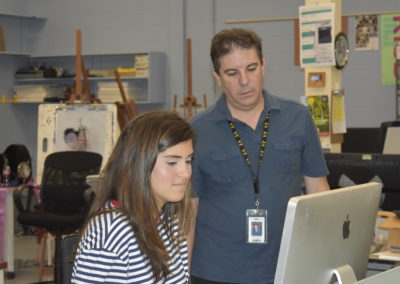 Visual Design student and teacher at computer