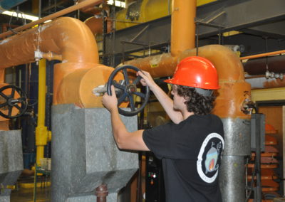 Stationary Engineering student turning wheel