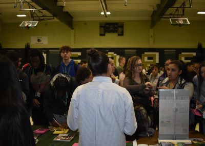 Multiple Students Asking Questions At BCC Booth