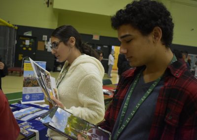 Student Looking At College Papers With Another Student