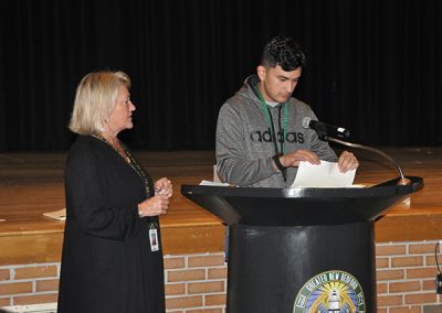 Student at the podium with teacher
