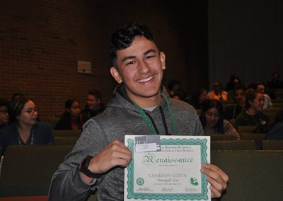 Student holding up renaissance award
