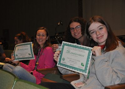 Students holding up renaissance awards