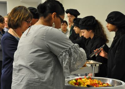 student serving food at event