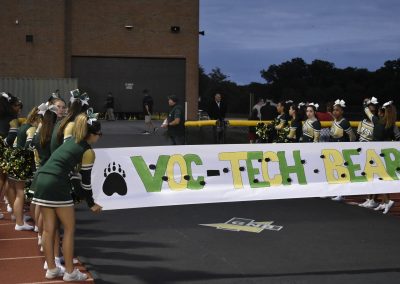cheerleader holding banner for players