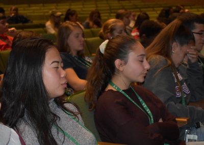 students with eyes closed in the audience
