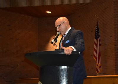 talking at podium with head down
