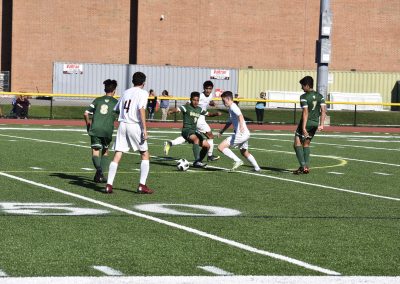 students trying to get soccer ball