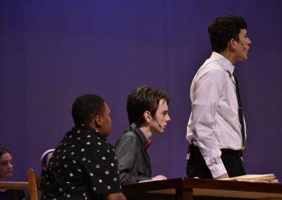 VTTC Actors on Stage. One is standing. (side view)