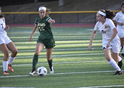 student kicking the soccer-ball