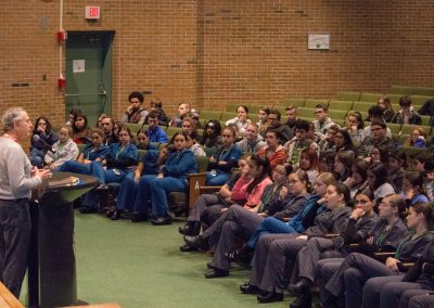 Quinn Talking To Students in theater wide shot