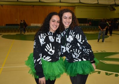 2 people taking picture after pep rally