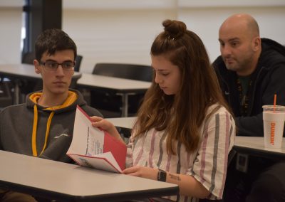 Student reading pamphlet