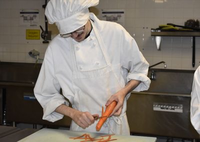 Student cutting carrot