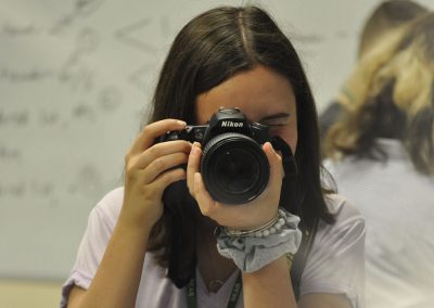 Student holding camera for picture