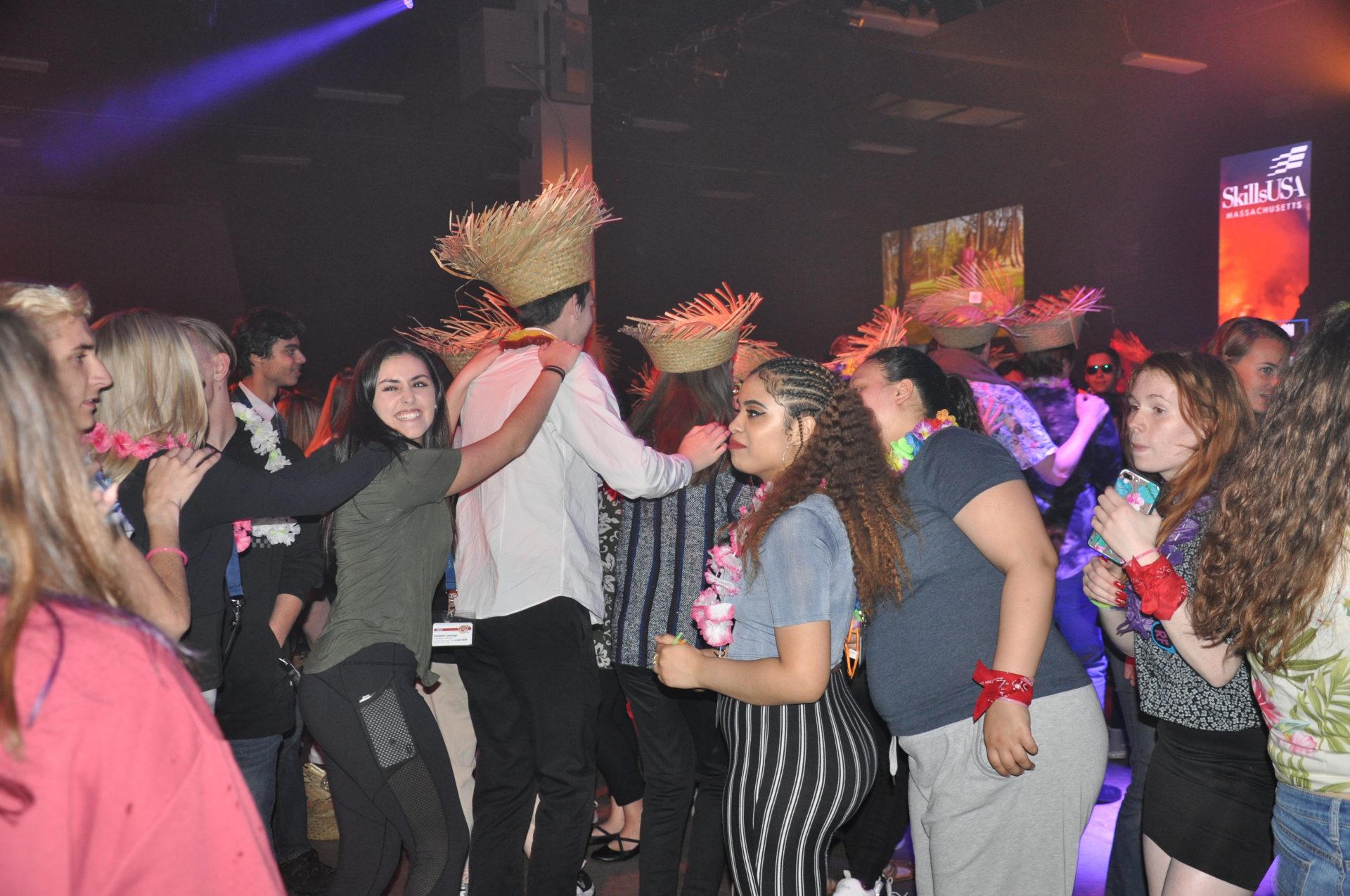 Students forming a conga line at the Hawaiian-themed party