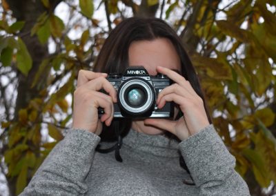olivia taking photos in the trees