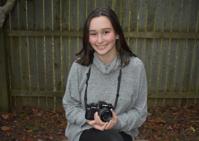 olivia smiling holding camera