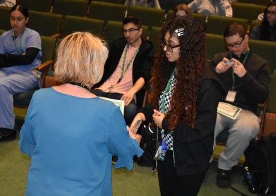 Renaissance Awards Ms Bouley shakes a students hand