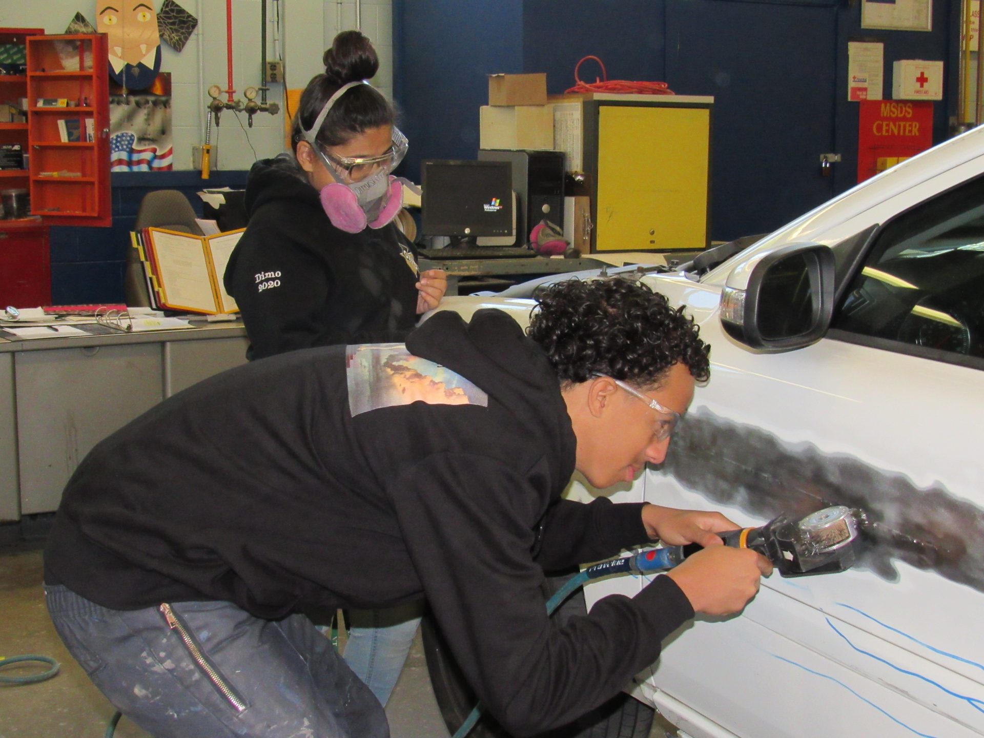 students working on car