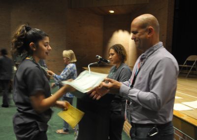 Student being handed two awards