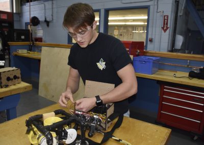 Jack working in shop on a machine.