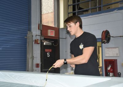 jack holding a hose into the pool