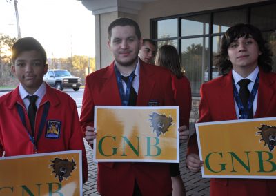 some students holding a "gnb" sign