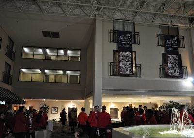 a photo of a water fountain with students surrounding it
