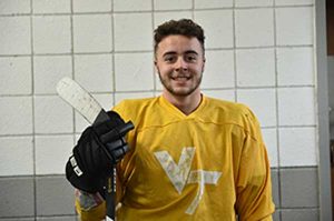 Hockey guy in yellow with a stick