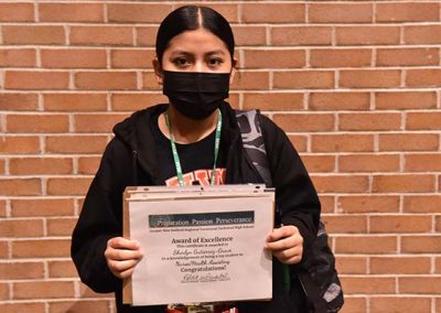 Student Taking Photo with Award 5