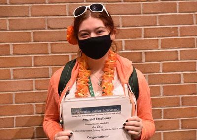 Student Taking Photo with Award 38
