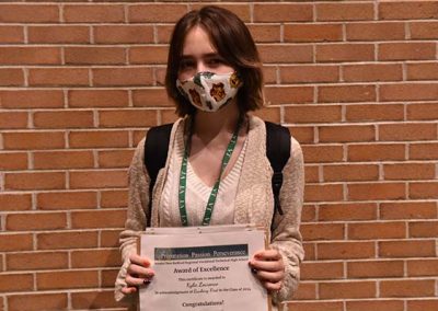 Student Taking Photo with Award 41