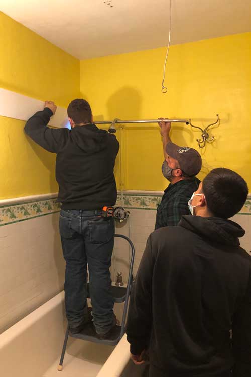 Outside Construction Students Fix OLOA Rectory Bathroom Pipe