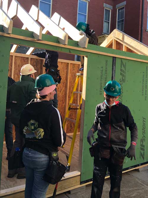 Off Campus Construction students working in house