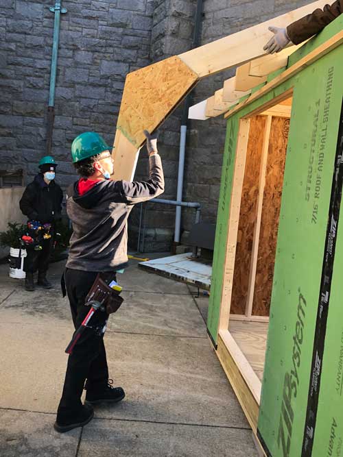 Off Campus Construction students putting up roof