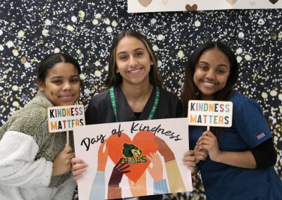 3 Students at Photobooth on Day of Kindness