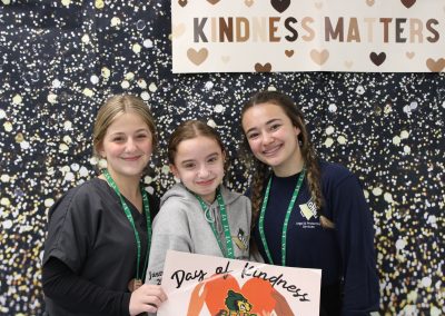 Three girls at photobooth on day of kindness