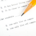 Exam Test paper with a pencil asking questions about college campus