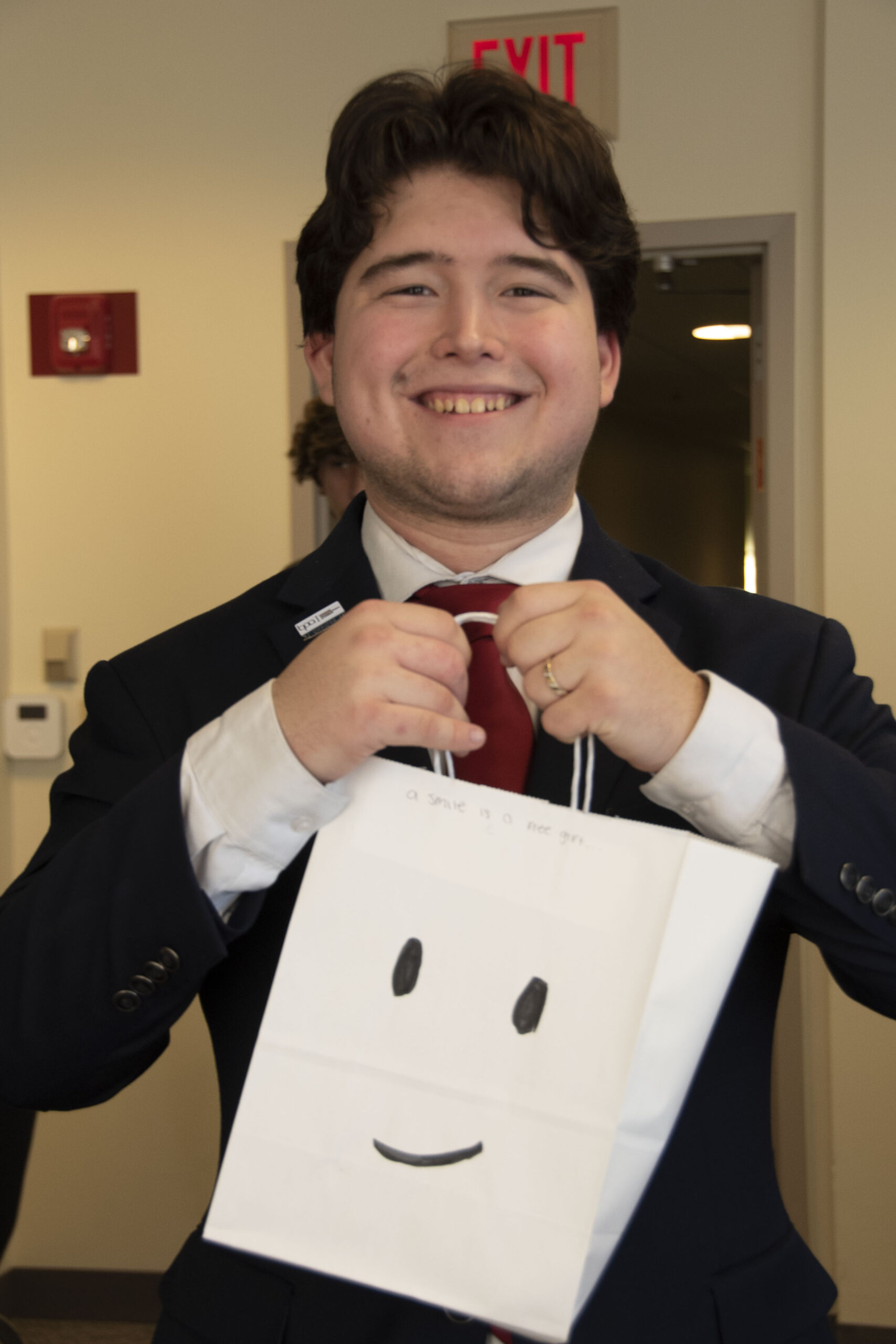 a student holding a small paper bag