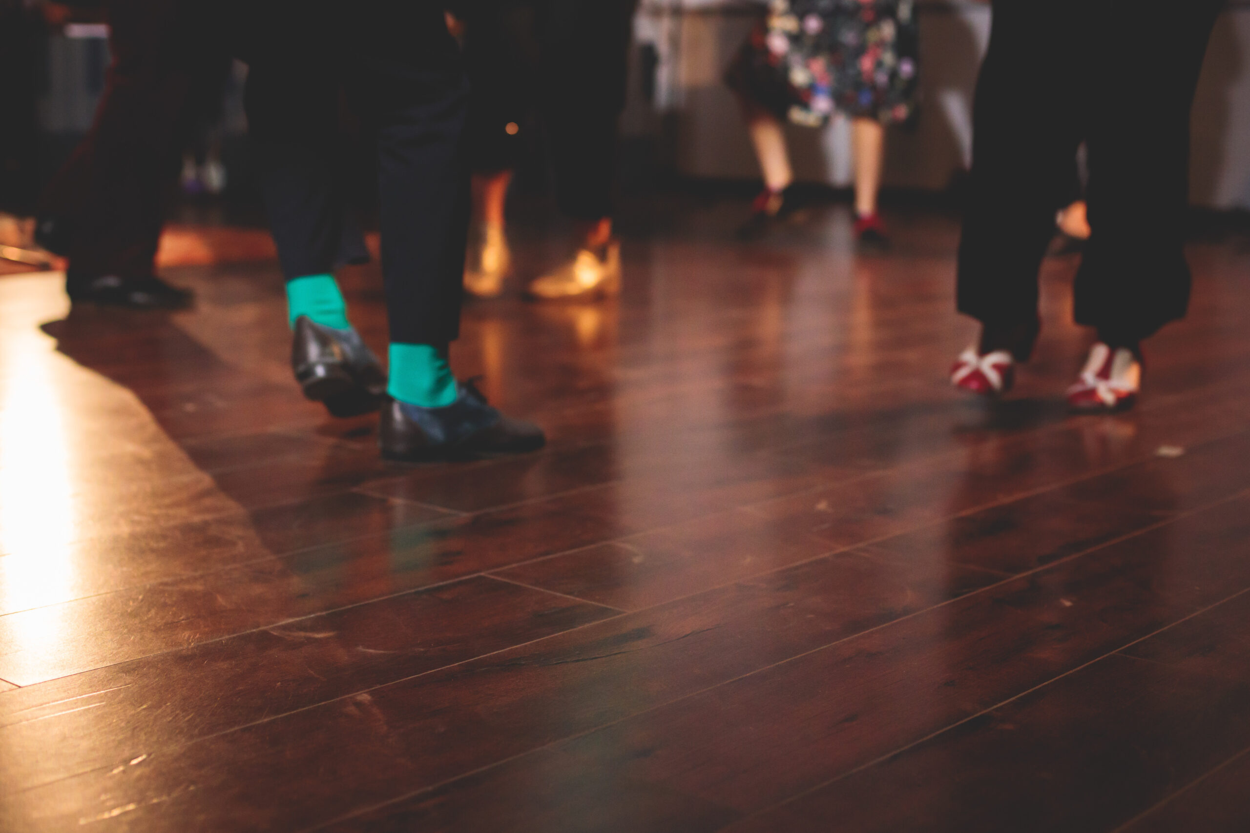 Dancing shoes of young couple dance retro jazz swing dances on a ballroom club wooden floor, close up view of a shoes, female and male, dance lessons class rehearsal